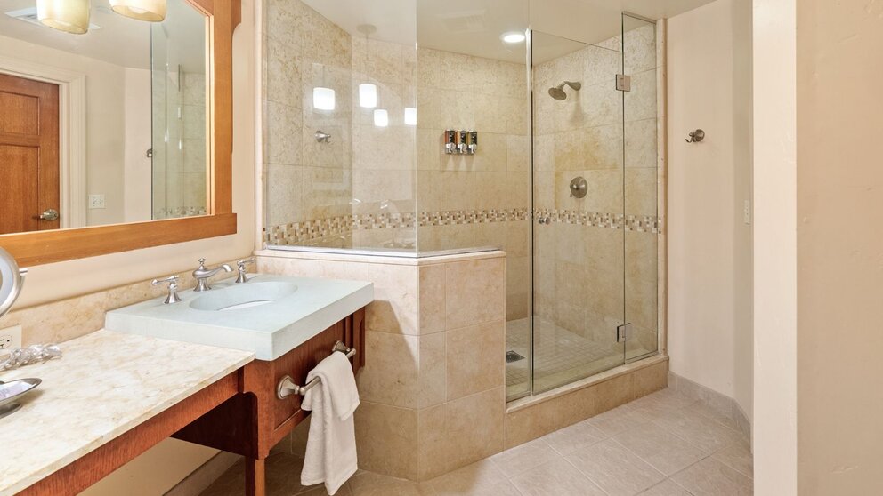 a bathroom with a glass shower and sink