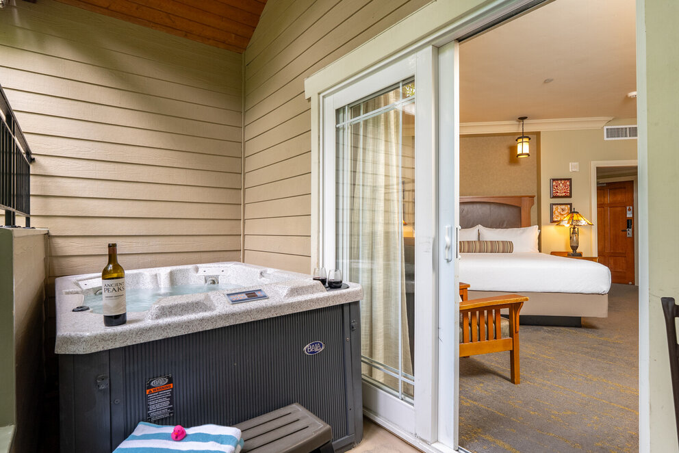 Deluxe Hot Tub room at Avila Village Inn with private patio hot tub and king bed.